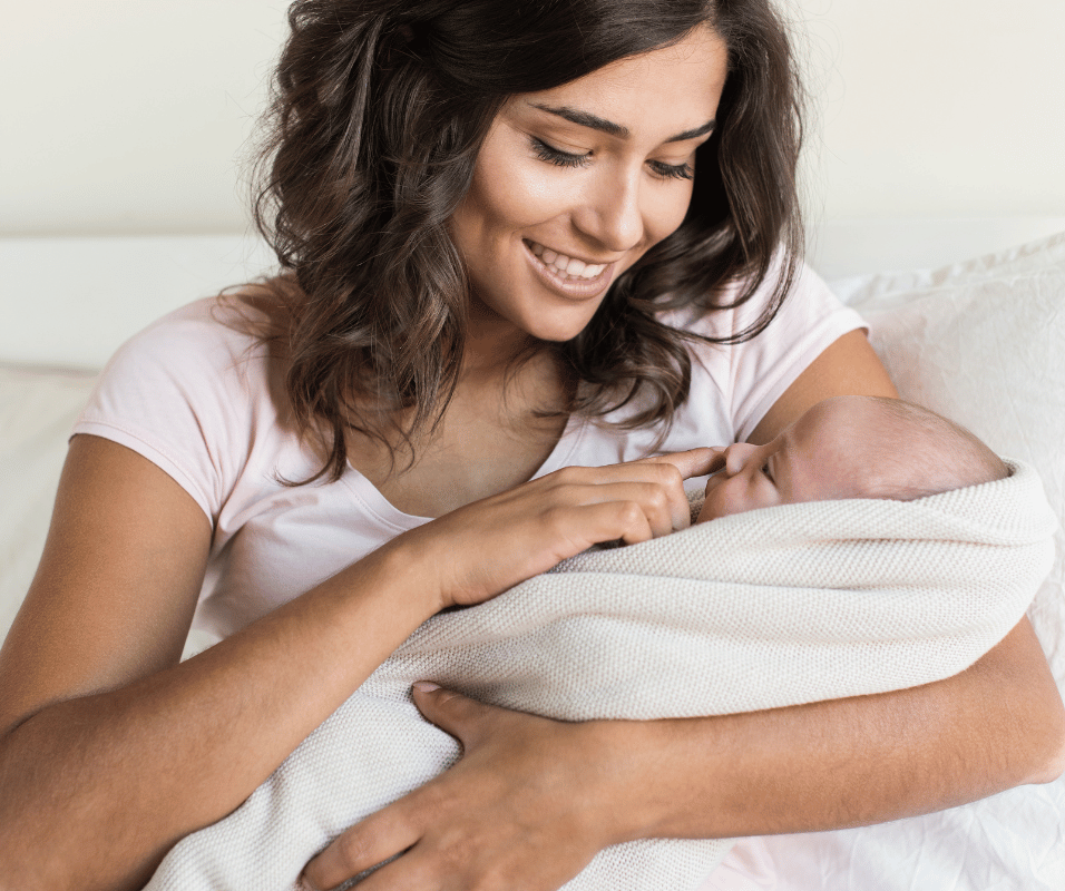 Smiling mother with young baby